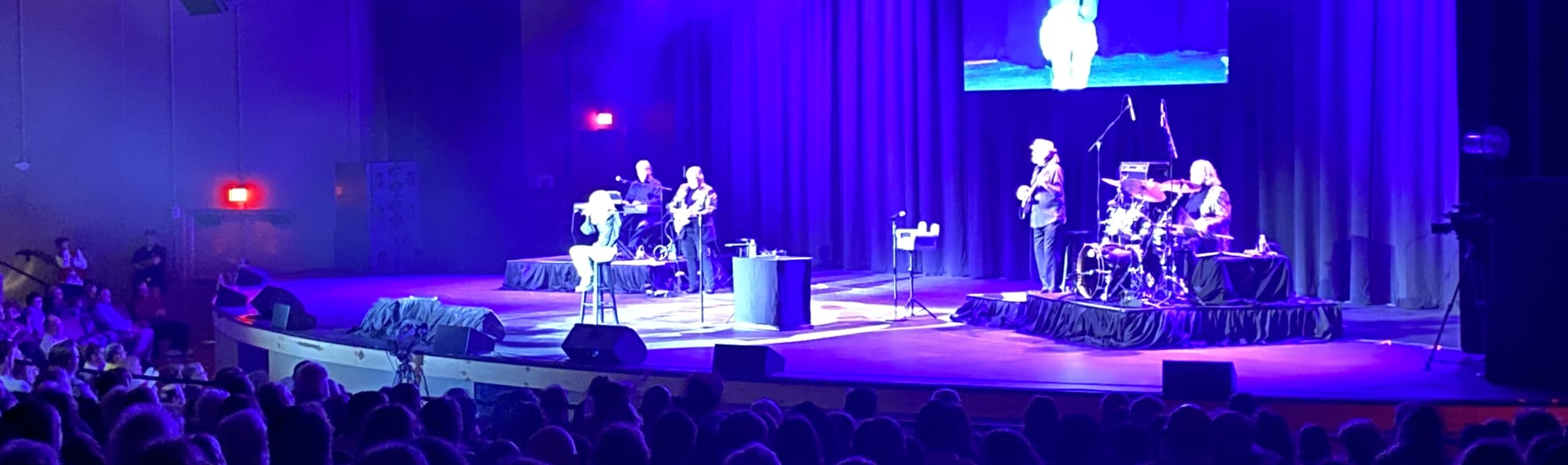 signer on stage in chair washed out by the lights Atlanta